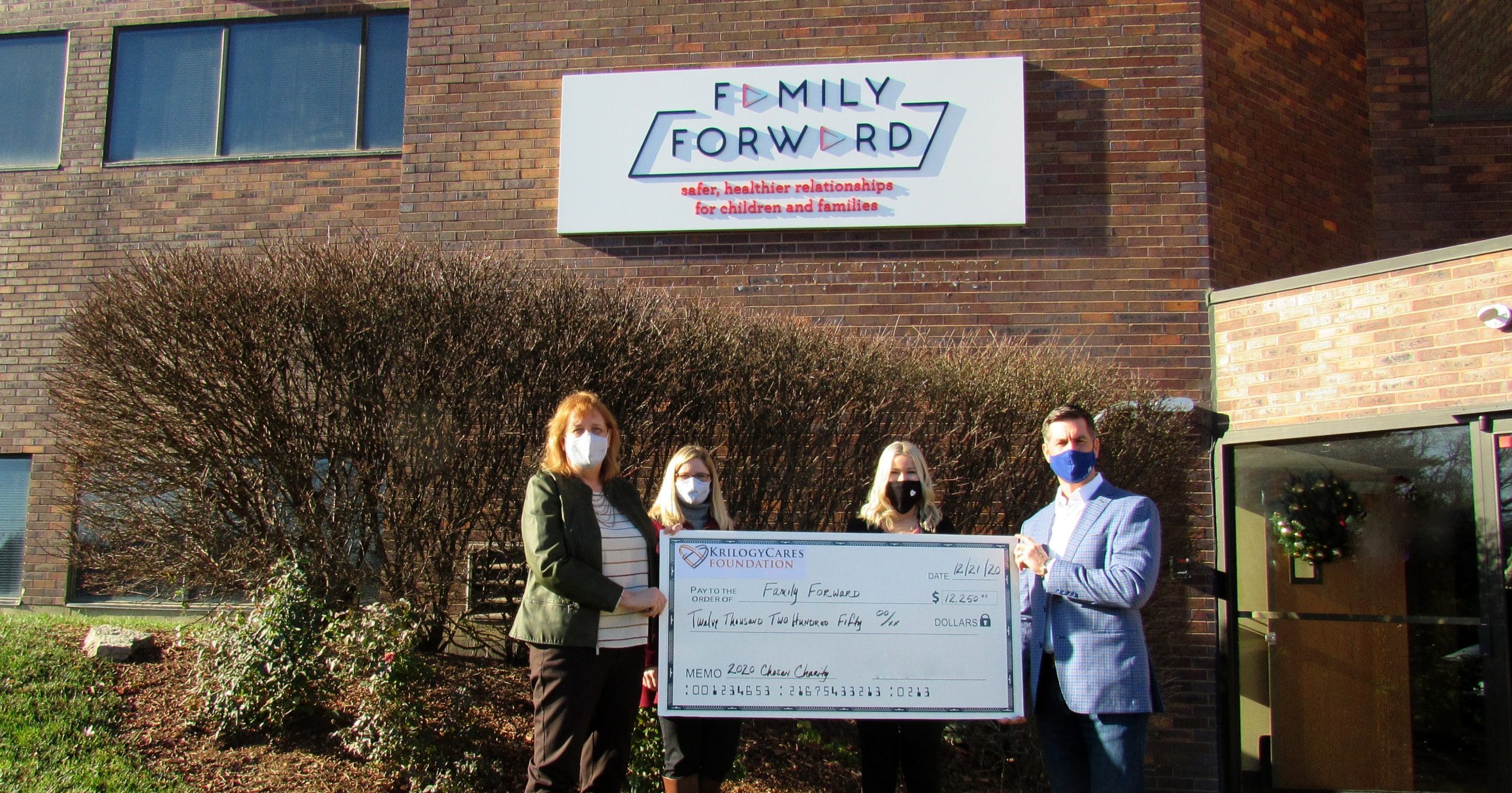 Krilogy presents check to FamilyForward, 2020 Krilogy Cares partner. 